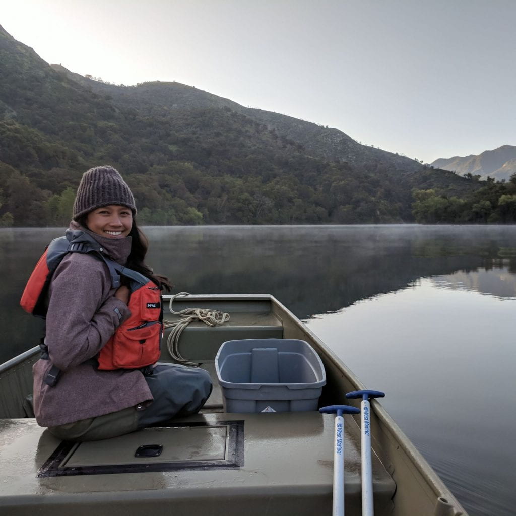 Dereka Chargualaf smiling on a boat in the Carmel River